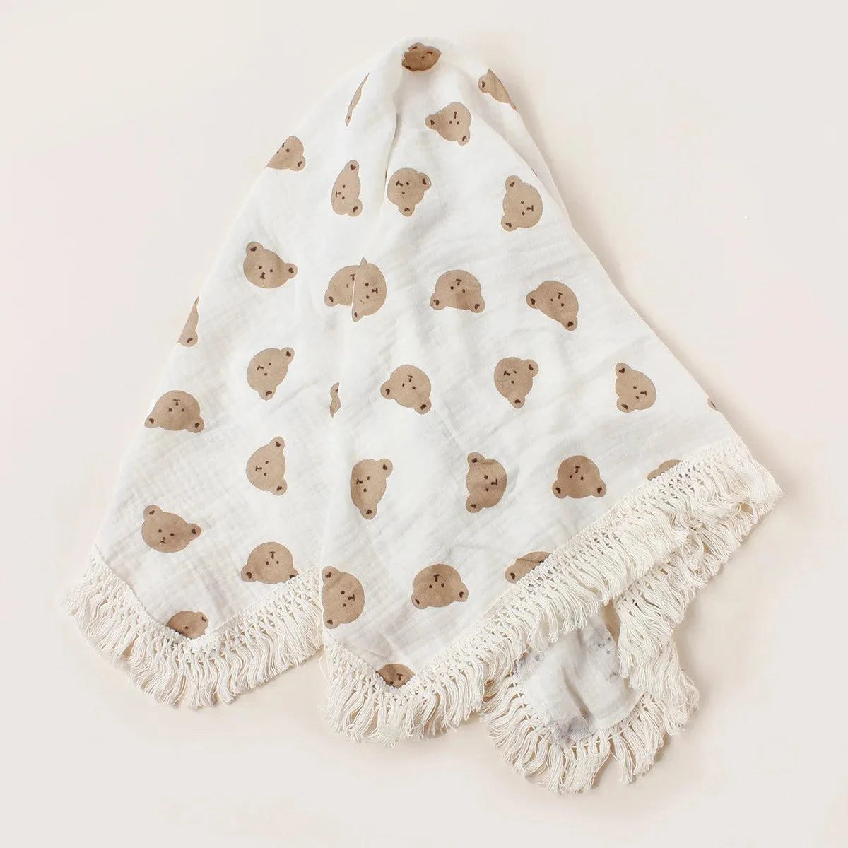 The Little Bear Tassel Blanket featuring soft fabric and a cute bear design with tassels for babies