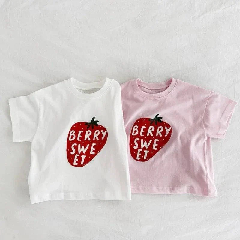 Child wearing soft cotton Berry Sweet Tee with cute berry-picking design, perfect for outdoor play and summer days