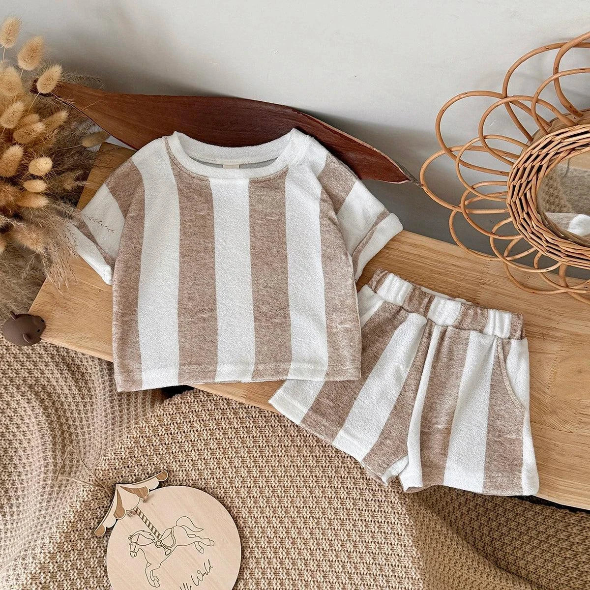 Child wearing Roman Stripe Shorts Set made of soft towelling fabric with classic stripes, ideal for summer and beachwear