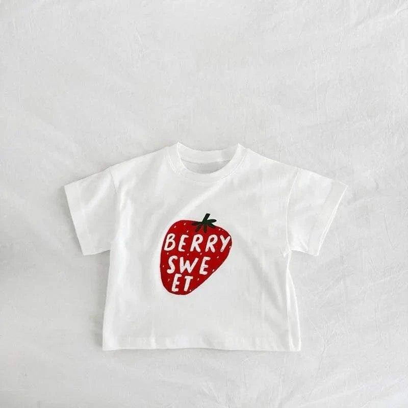 Child wearing Berry Sweet Tee with cute berry-picking design outdoors